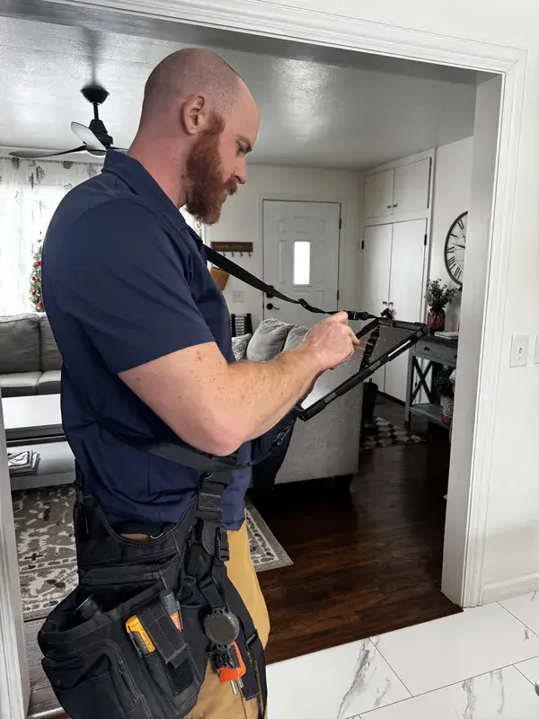 HomeStart inspector documenting findings on a tablet during a home inspection