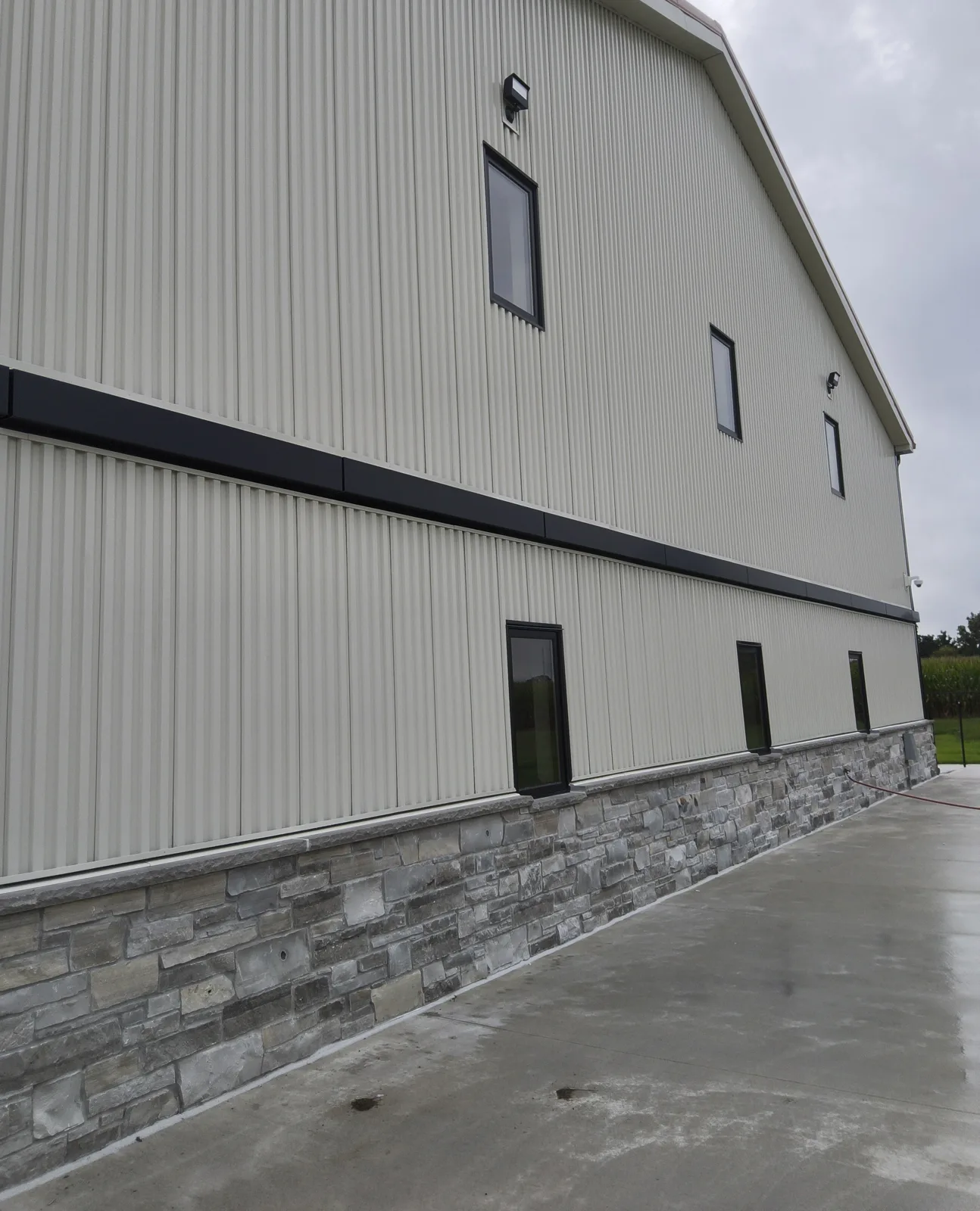 Steel wall panels over a stone wainscot on a barndominium near Milton, WI