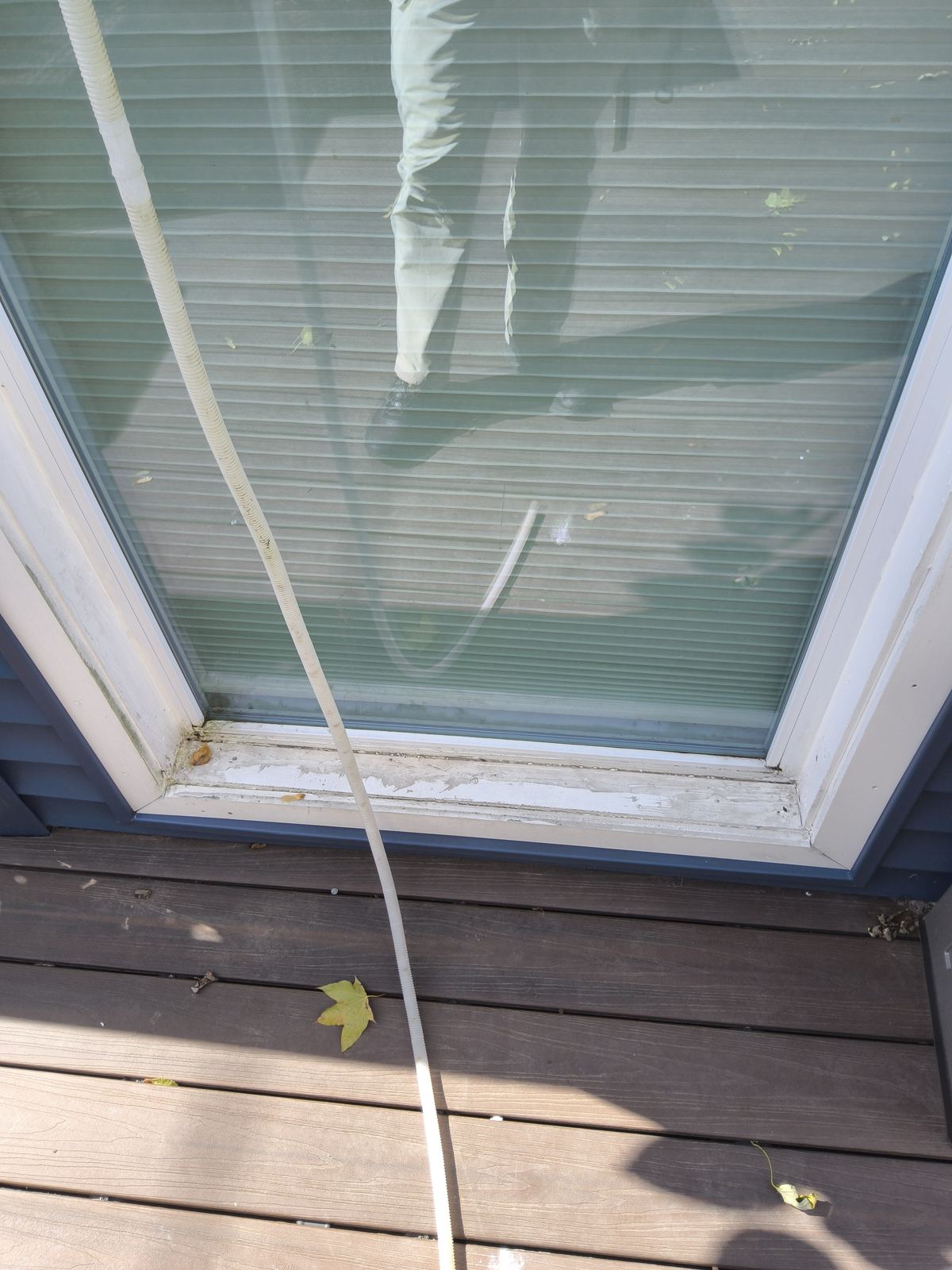 Exterior door threshold and deck checked for water entry during a Dane County home inspection