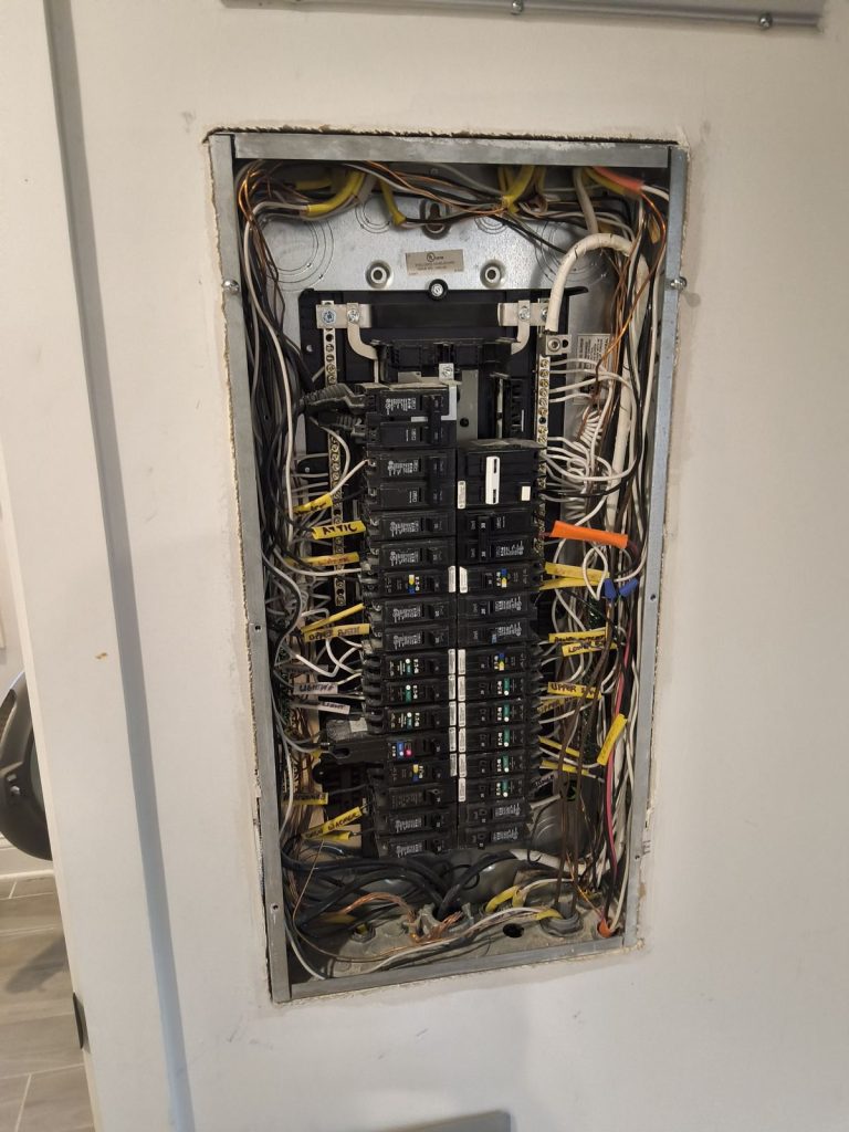 Open electrical panel being evaluated during a home inspection in Wisconsin