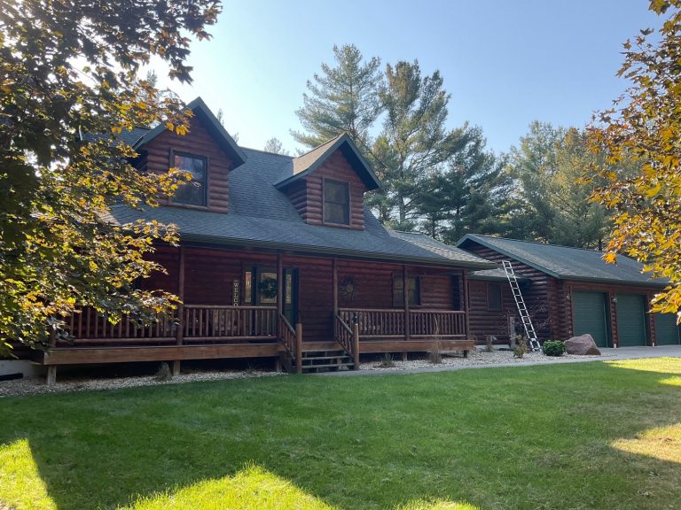 Two-story log home with dormers, wraparound porch and attached log garage inspected in central Wisconsin