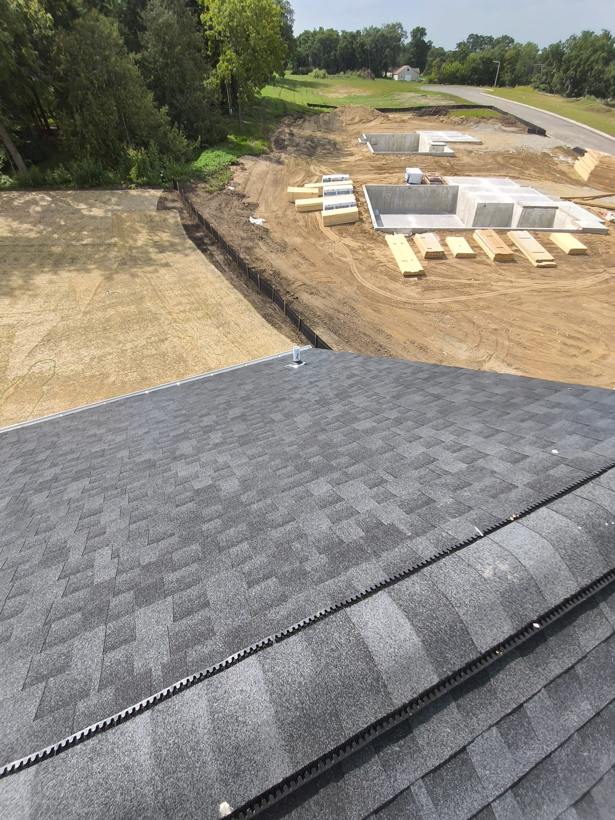 View from a new home's roof over a developing subdivision with foundations going in near Madison, WI